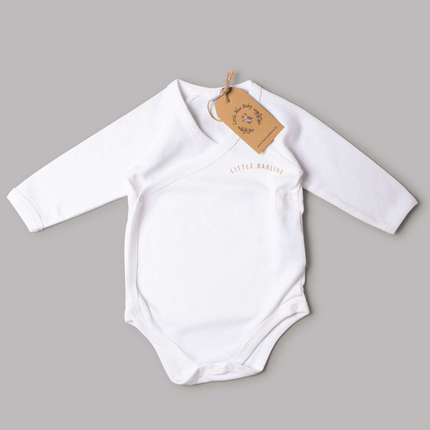 White wrap over Little Darling bodysuit with long sleeves and tag, perfect for stylish and comfortable baby wear.